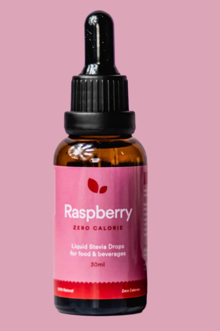 Bottle of raspberry liquid stevia drops on a pink background