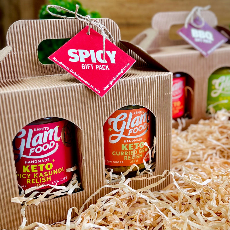 Gift pack of Glam Food products with a spicy tag on a wooden surface.